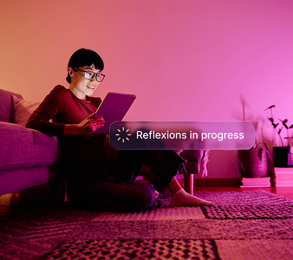 woman sitting on the floor using a tablet, with an AI reflection process in progress