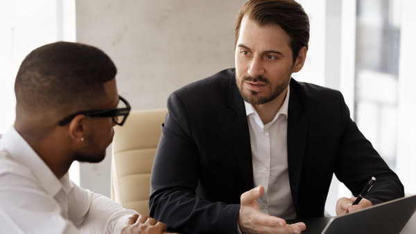 Two male professionals discussing business strategy