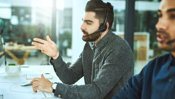Young man wearing headset working as customer support agent
