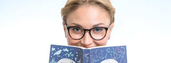 Woman weraing glasses and holding a book