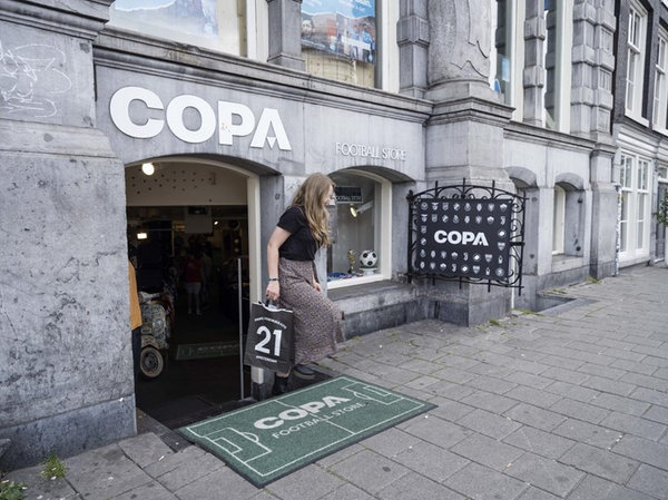 Woman coming out of the COPA store