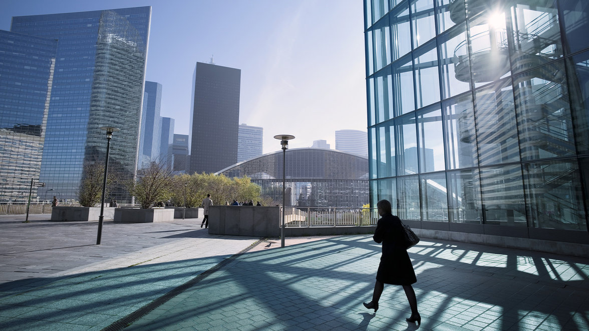 Silhouette of businesswoman walking towards center of business district in Paris
