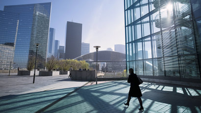 Silhouette of businesswoman walking towards center of business district in Paris