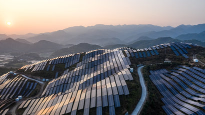 Aerial view of the solar power plant on the top of the mountain at sunset showing greener payments in our payments podcast
