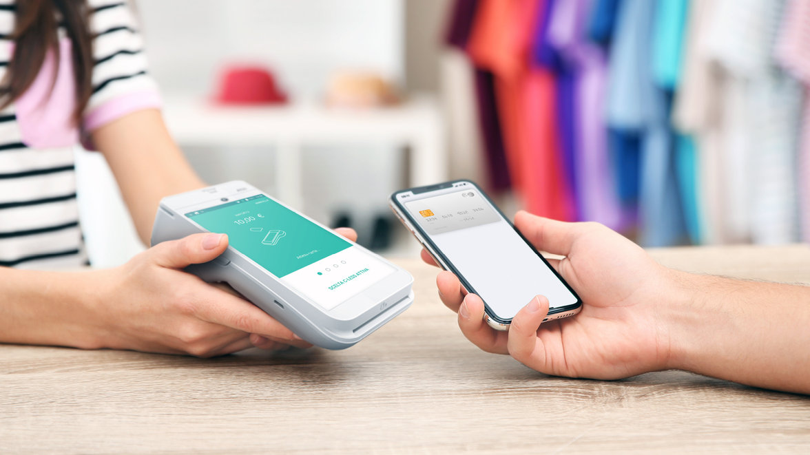 contactless payment smartphone woman holding pos terminal