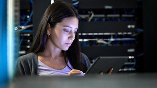 Female engineer working in server room