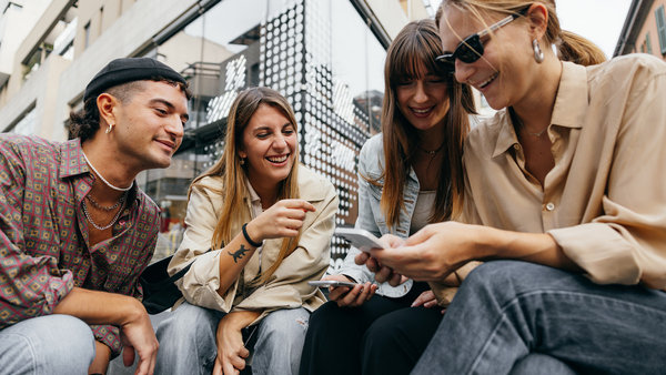 group of generation Z friends looking on social-media using online payments service