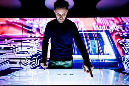 man using a digital screen table
