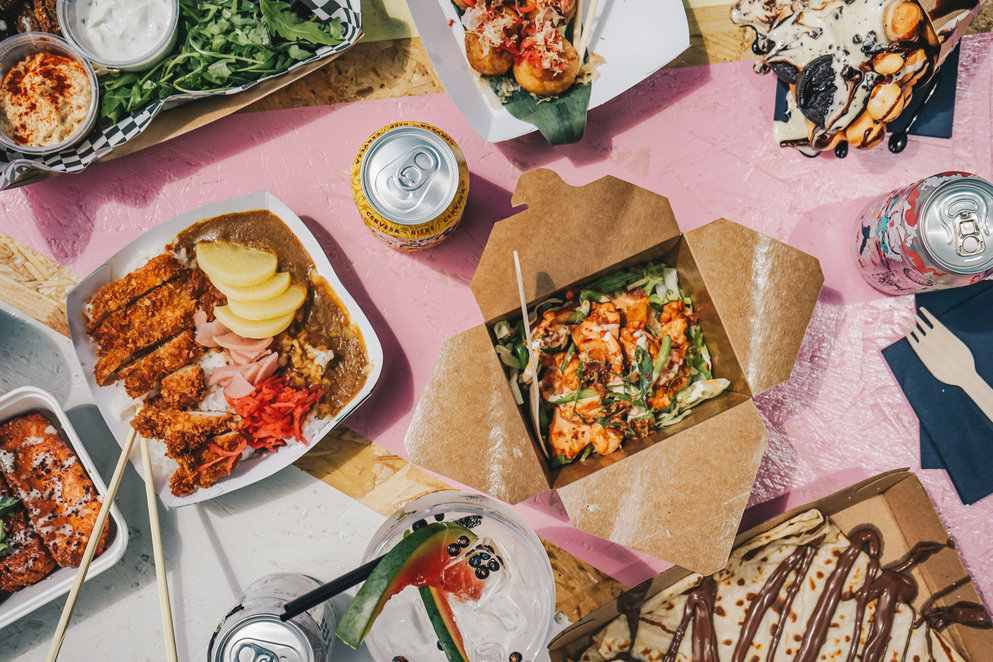 Table top view of food ready to eat in takeaway boxes