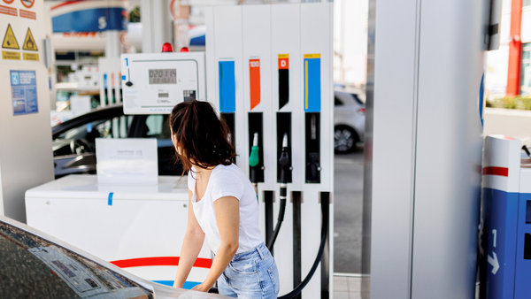 woman filling her car with petrol at the gaz station