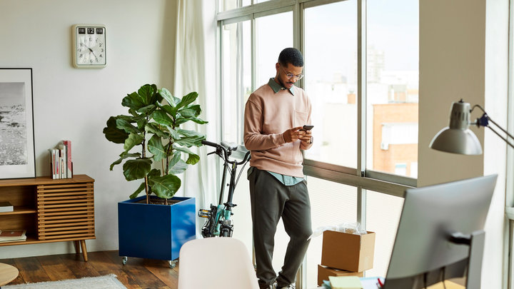 img-full-young-man-using-mobile-phone-at-home-office