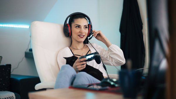 young woman playing computer game using digital products and services