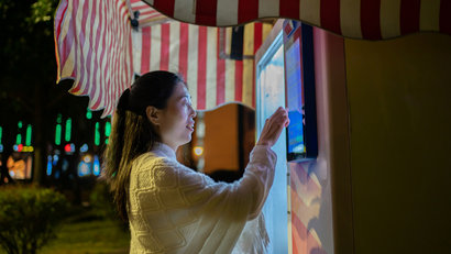 woman touching the screen of a smart friedge