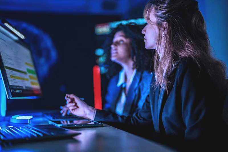 two women working at their laptops