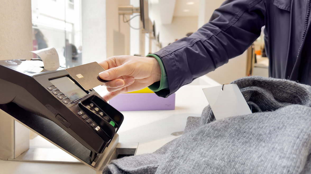 A man paying with a credit card at a payment terminal