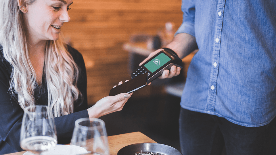 womand making a payment at restaurant