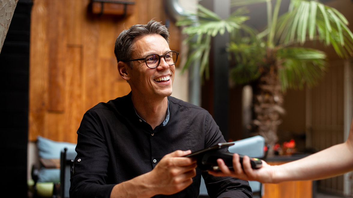 Man paying with his card at a restaurant