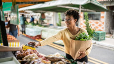 header-woman-paying-with-her-phone-at-a-market