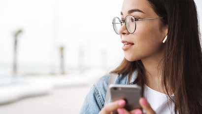 young woman checking smartphone thinking about open finance and embedded finance 2022