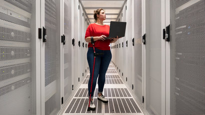 Woman with a damaged hip joint working in data centre
