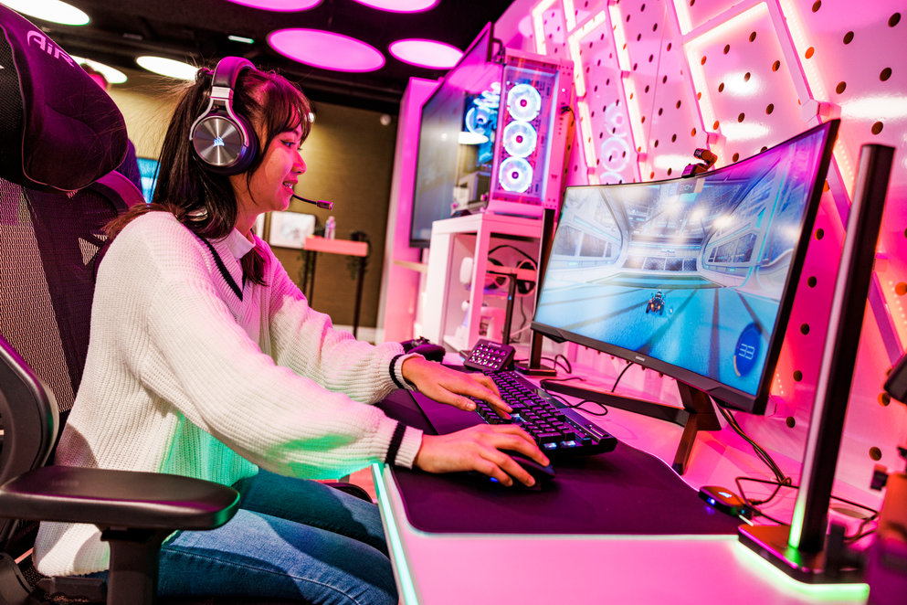 Young asian woman playing computer video game