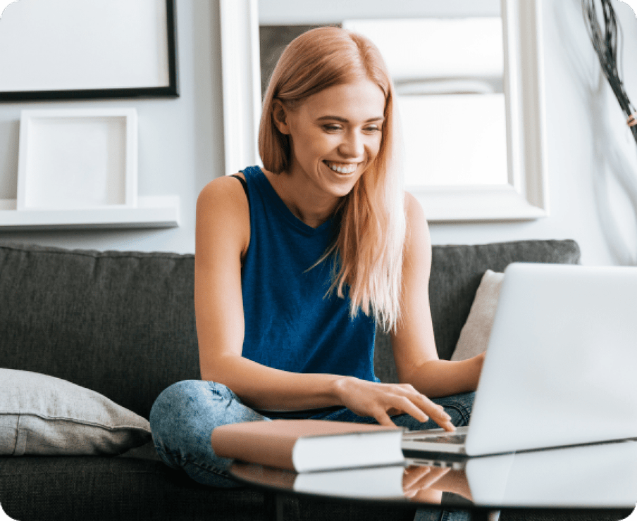 Woman sitting on a couch watching her laptop