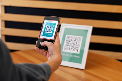 Alt text - Indian traveler making UPI payment at an international merchant showcasing seamless cross-border digital transactions