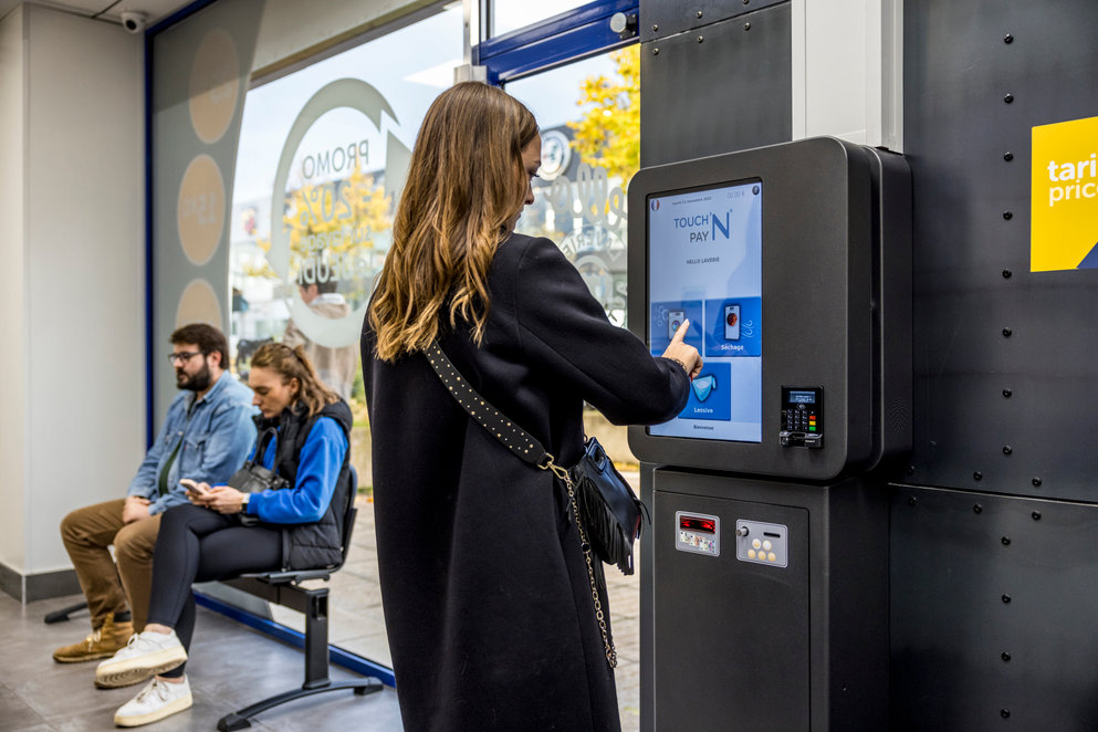 woman completing a purchase in a vending machine