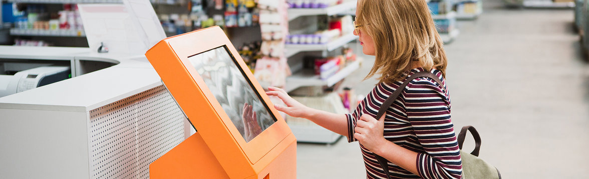 Woman making selection on vending machine
