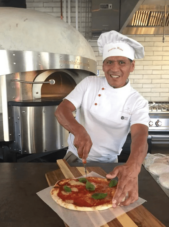 David Smith cutting a pizza